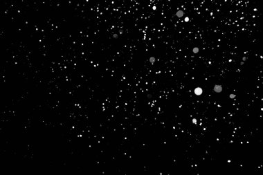 Kar fırtınası doku. Siyah arka plan, ışıkları bokeh vurdu kar taneleri havada uçan