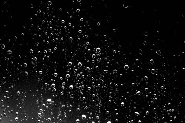 Siyah cam üzerinde yağmur damlaları