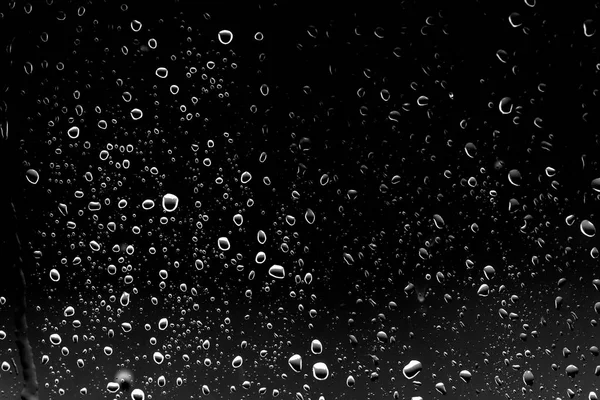 Siyah cam üzerinde yağmur damlaları
