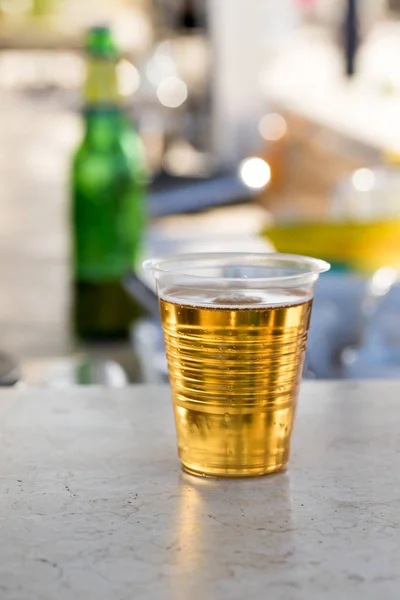 beer in a plastic glass on the table