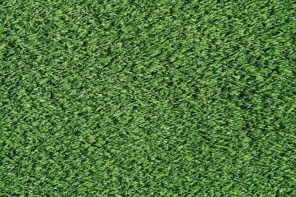 緑の芝生の人工フィールドの背景 — ストック写真