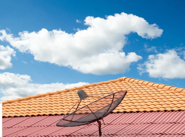 antenna on the roof of the house, sky and clouds