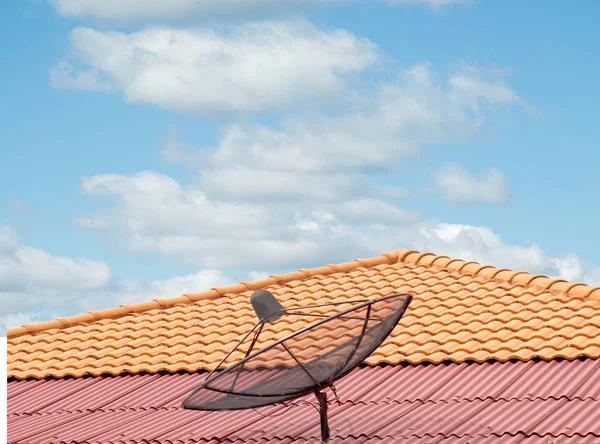 antenna on the roof of the house, sky and clouds