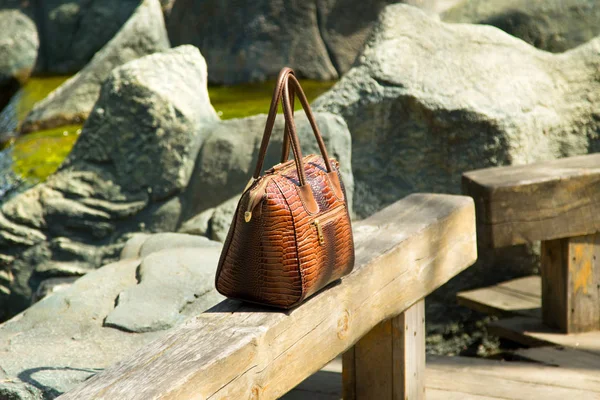 leather bag on a bench in the street