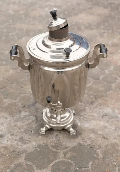 Metal russian samovar on ground