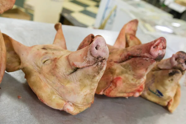 meat, pig heads on the table