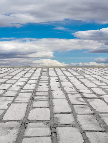 old brick road on the blue sky background