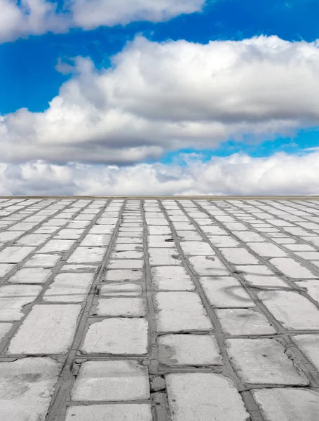 old brick road on the blue sky background