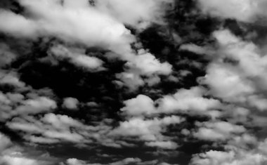 Beyaz bulutların üzerinde karanlık bir gökyüzü, tek renkli