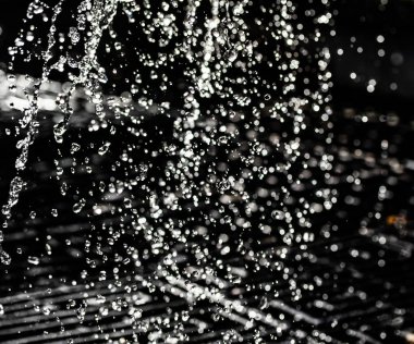 İçinde karanlık bir uçuş, ufuk bokeh su damlaları ile su sıçrama.