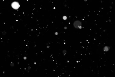 Kar fırtınası doku. Siyah arka plan, ışıkları bokeh vurdu kar taneleri havada uçan