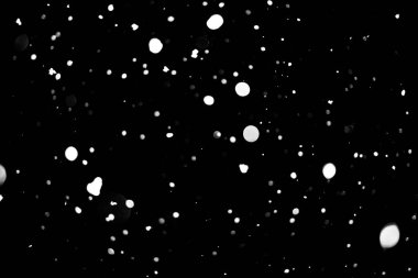 siyah kar bokeh arka plan üzerinde beyaz noktalar