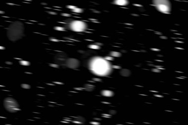 hareket bulanık siyah bir arka plan üzerinde beyaz noktalar kar