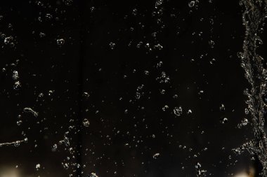 İçinde karanlık bir uçuş, ufuk bokeh su damlaları ile su sıçrama.