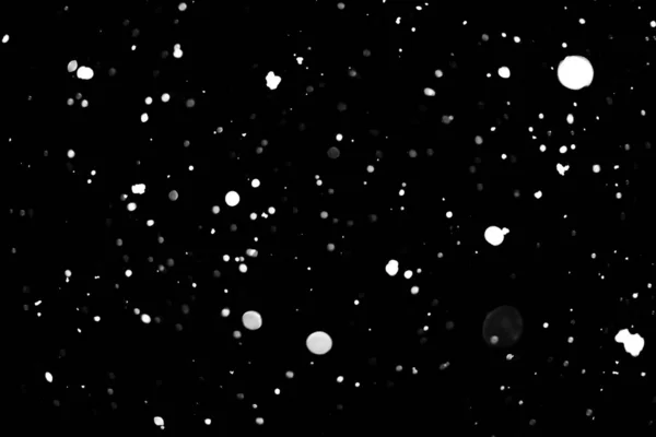 白点在黑色雪 Bokeh — 图库照片