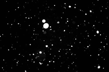 siyah kar bokeh arka plan üzerinde beyaz noktalar