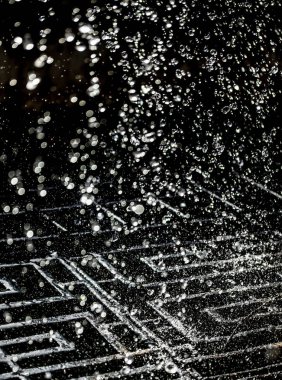 İçinde karanlık bir uçuş, ufuk bokeh su damlaları ile su sıçrama.