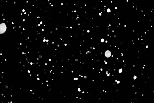 white dots on black snow bokeh background