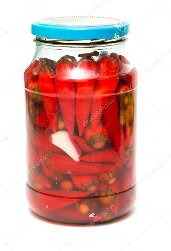 close-up view of pickled chili peppers in glass jar isolated on white