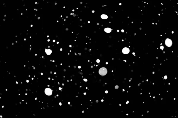 white dots on black snow bokeh background