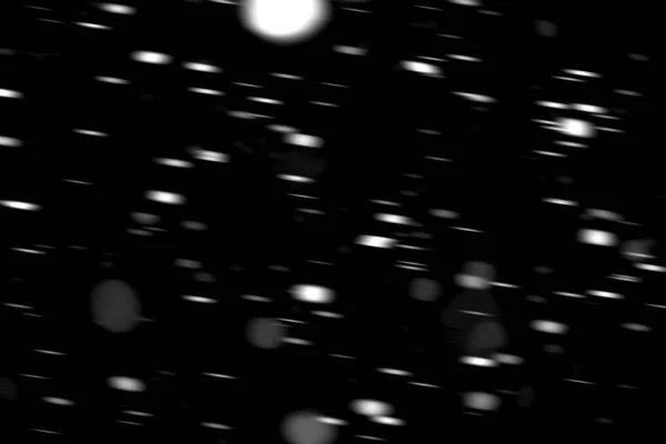在黑色背景模糊的运动中的白点雪 — 图库照片