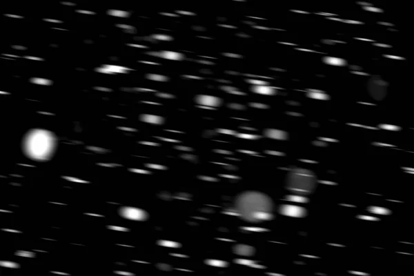 在黑色背景模糊的运动中的白点雪 — 图库照片