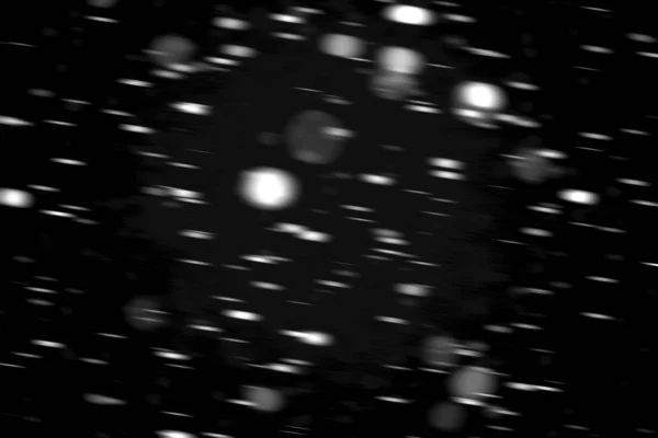 ぼやけて黒い背景上のモーションで雪の白ドット — ストック写真