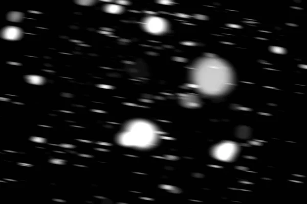 stock image white dots snow in motion on a black background blurry