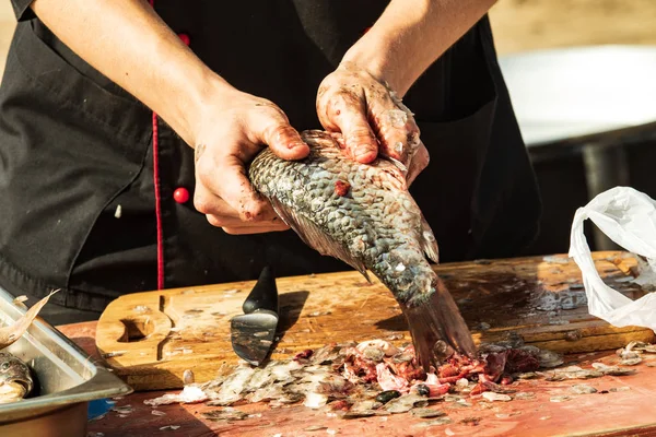 clean hands with a knife fresh fish