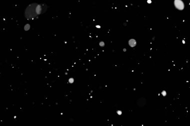 Kar fırtınası doku. Siyah arka plan, ışıkları bokeh vurdu kar taneleri havada uçan