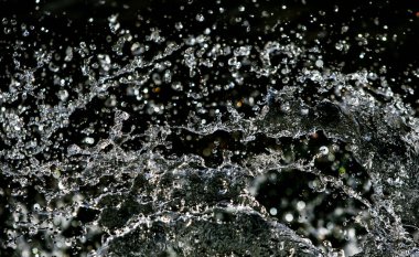 İçinde karanlık bir uçuş, ufuk bokeh su damlaları ile su sıçrama.