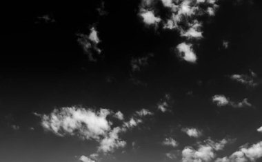 Beyaz bulutların üzerinde karanlık bir gökyüzü, tek renkli