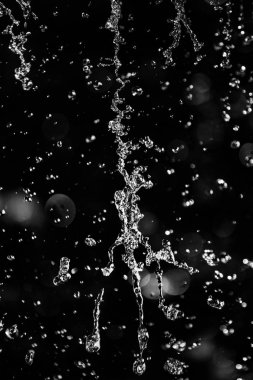 İçinde karanlık bir uçuş, ufuk bokeh su damlaları ile su sıçrama.