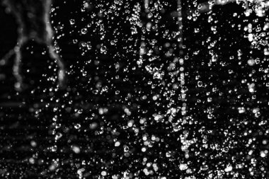 İçinde karanlık bir uçuş, ufuk bokeh su damlaları ile su sıçrama.