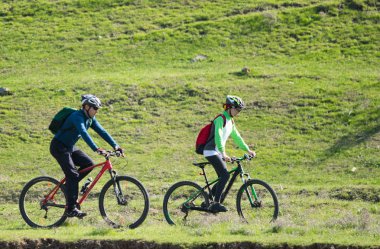 Kazakistan, Çimkent - 23 Nisan 2017. Bozkır yeşil çim bisikletçiler binmek.