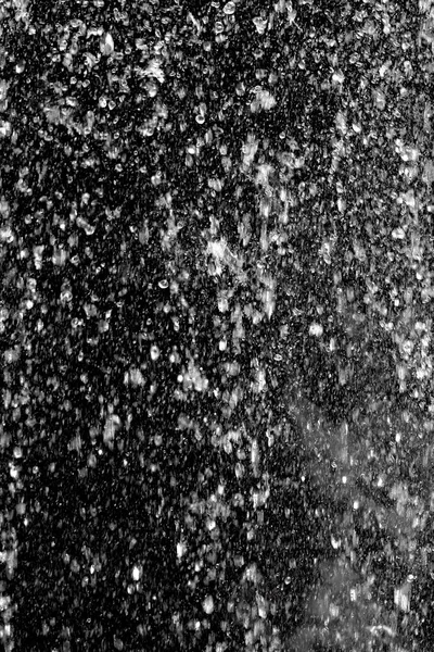 Splashing water is out of focus on a black background