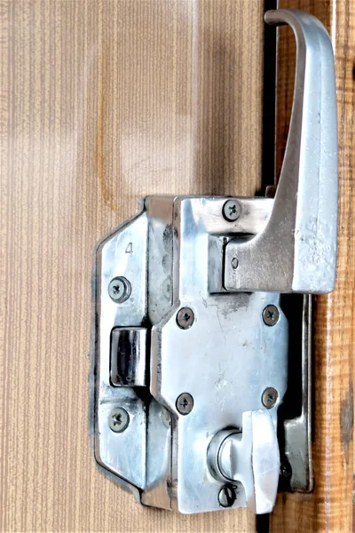 Metal door handle inside train cabin