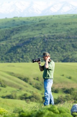 Shymkent, Kazakhstan - 04 May 2017: The guy with the camera, shoots the landscape.