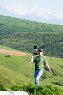 Shymkent, Kazakhstan - 04 May 2017: The guy with the camera, shoots the landscape.