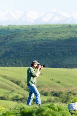 Shymkent, Kazakhstan - 04 May 2017: The guy with the camera, shoots the landscape.