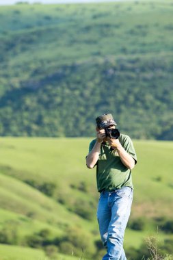 Shymkent, Kazakhstan - 04 May 2017: The guy with the camera, shoots the landscape.