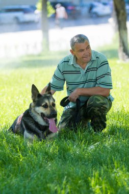 Shymkent, Kazakistan - 13 Mayıs 2017: Şehir Parkı bir köpek ile bir adam.
