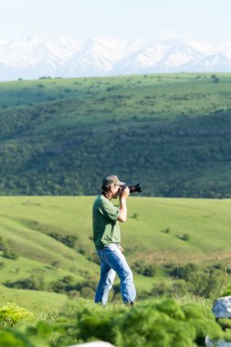 Shymkent, Kazakhstan - 04 May 2017: The guy with the camera, shoots the landscape.