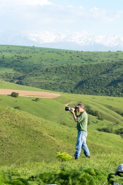 Shymkent, Kazakhstan - 04 May 2017: The guy with the camera, shoots the landscape.