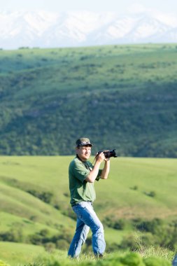 Shymkent, Kazakhstan - 04 May 2017: The guy with the camera, shoots the landscape.