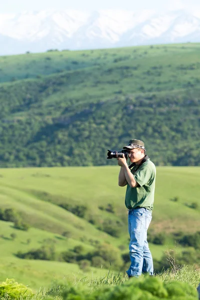 Shymkent, Kazakhstan - 04 May 2017: The guy with the camera, shoots the landscape.