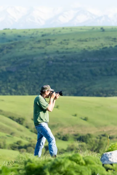 Shymkent, Kazakhstan - 04 May 2017: The guy with the camera, shoots the landscape.