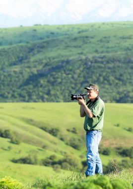 Shymkent, Kazakhstan - 04 May 2017: The guy with the camera, shoots the landscape.