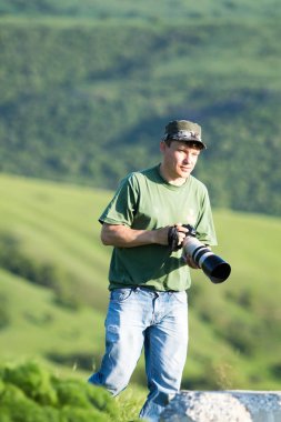 Shymkent, Kazakhstan - 04 May 2017: The guy with the camera, shoots the landscape.