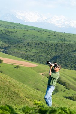 Shymkent, Kazakhstan - 04 May 2017: The guy with the camera, shoots the landscape.